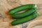 Green zucchini freshly picked on olive wood table.