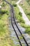 Greenery grasses railroad tracks among mountain