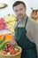 Greengrocer with basket produce