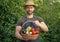 greengrocer in straw hat hold basket full of vegetables