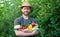 greengrocer in straw hat hold fresh ripe vegetables