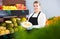 Greengrocery salesgirl offering melon