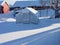 Greenhouse covered in snow