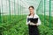 Greenhouse female inspector checking plants