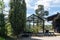 Greenhouse glass house in the garden near the villa. Landscape garden design. Greenhouse for growing plant seedlings. In the yard