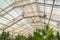 Greenhouse interior with lights ceiling fan and sprinklers under the glass roof