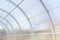 Greenhouse made of polycarbonate and metal carcass. Small hothouse. Metal construction covered with transparent polycarbonate