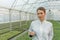 Greenhouse Seedlings Growth. Female Agricultural Engineer