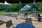 greenhouse table and chairs with sunshade in garden