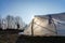 Greenhouse tunnel from polythen plastic backlit by the sun on an