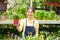 Greenhouse Worker with Fern Plant