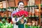 Greenhouse worker holding flower pots