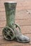 Greenish bronze statue of leg with shoe on wheels, Newcastle, Australia