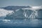 Greenland. The biggest glacier on a planet Jakobshavn. Huge icebergs of different forms in the gulf. Studying of a