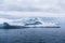 Greenland. The biggest glacier on a planet Jakobshavn. Huge icebergs of different forms in the gulf. Studying of a