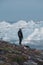 Greenland tourist man explorer overlooking Icefjord in Ilulissat. Travel in arctic landscape nature with icebergs