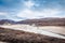 Greenlandic wastelands landscape with river and mountains in the
