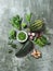 Greens and green vegetables on gray background