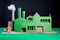 Greenwashing concept with green cardboard factory. Generative AI illustration