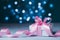 Greeting card for Christmas, New Year or wedding. White gift box or present with pink bow ribbon against magic bokeh background.