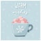 A greeting card. Cute cocoa mug with marshmallow and snowflake and handwritten words - Warm wishes. Blue background with