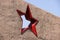 Greeting card with the day of the defender of the fatherland. February 23. red five-pointed star in a concrete wall against a blue