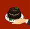 Greeting card with the image of two-level chocolate cake with the words Happy Birthday and cherries in a hand