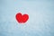 Greeting card with lonely heart on the dazzling blue snow