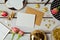 Greeting card mock up template with rose flowers and chocolates on wooden background. View from above