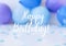 Greeting card postcard Happy Birthday text on Abstract defocused blurred festive background for holiday. Blue ballons and confetti