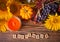 Greeting card with September text. Composition with pumpkin, autumn leaves and berries. Cozy autumn mood concept