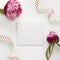 Greeting card template decorated by peony flowers and polka-dot ribbon