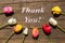 Greeting card with Tulips on wooden table with words Thank you