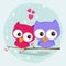 Greeting card two loving owls, happy birds are sitting on a tree.