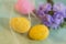 Greeting cards for Easter, print and poster. Holiday concept. Two yellow eggs in a transparent cloth. Blurred flowers.