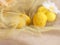 Greeting cards for Easter, print and poster. Holiday concept. Yellow eggs in a transparent cloth. Blurred flower.