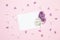 Greeting empty card template with white lilac flower on a pink background