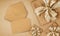 Greeting gift card, top view of wrapped packages of champagne color with golden ribbon bow, envelope and ticket, isolated on beige