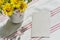 Greeting mockup scene on striped cotton napkin. Blank paper, bouquet of yellow wild meadow flowers