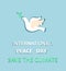 Greeting pastel blue card with paper cut out dove with olive branch and International Peace day and save the climate lettering. Fl