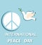 Greeting pastel blue card with paper cut out dove and peace symbol for International Peace day