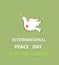 Greeting pastel green card with paper cut out dove with olive branch and International Peace day and save the climate lettering. F