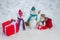 Greeting snowman family, parenthood concept. Cute snowmen family with - gift presents standing in winter Christmas