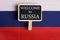 Greeting for traveler concept - Russia Flag and blackboard with text Welcome to Russia