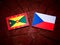 Grenada flag with Czech flag on a tree stump