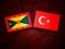 Grenada flag with Turkish flag on a tree stump