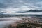 Grenoble cityscape, aerial view of Grenoble city with clouds and mountain background