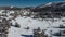 Greolieres ski slope and trees covered in snow, drone aerial view in winter