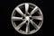 grey alloy wheel, modern auto parts. black background front view