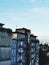 Grey apartment building against blue sky and moon in the corner